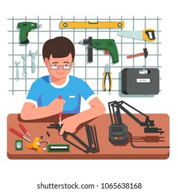 Young electronics and mechanical engineer assembling or fixing diy robot arm manipulator using screwdriver. Engineer working at his garage surrounded by instruments. Flat vector illustration