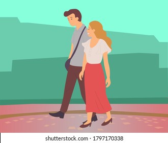 Young embarrassed shy guy and girl walking in summer garden, romantic walk. People man and woman met on a date outdoor. Couple walking in a park. Smiling friends in the open air, active lifestyle