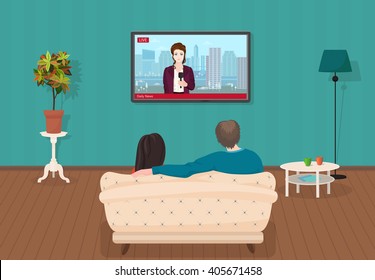 Young family man and women watching TV daily news program together in the living room. 