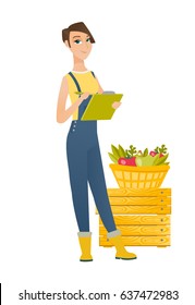 Young farmer holding clipboard and taking some notes on the background of basket with fruits and vegetables. Farmer writing on clipboard. Vector flat design illustration isolated on white background.