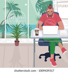 Young fashionable designer or hipster manager sitting at table and working on white laptop. Outside office windows tropical landscape. Simplistic realistic style. Vector illustration