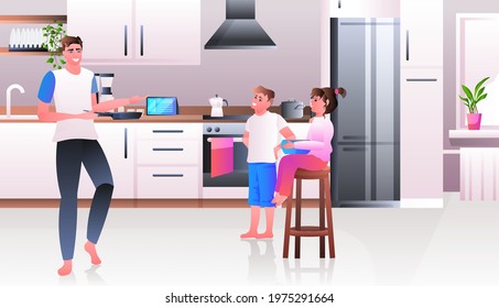 young father cooking with childrent at kitchen fatherhood parenting concept horizontal
