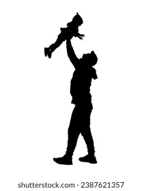 Young father lifting his baby up high in the air silhouette.	