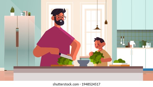 young father and little son preparing healthy vegetables salad at home kitchen parenting fatherhood concept