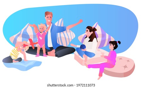 young father playing with little children at home fatherhood parenting concept dad spending time with his kids