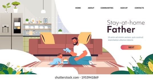 young father playing with little son at home fatherhood parenting concept dad spending time with baby