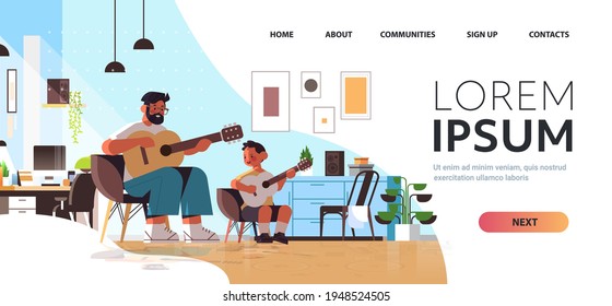 young father teaching little son to play the guitar at home parenting fatherhood concept living room interior