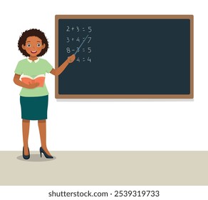 Young female African teacher standing in front of class teaching math lesson at blackboard