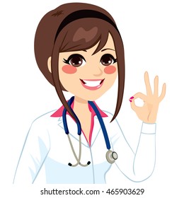 Young female doctor making okay sign with hand isolated on white background