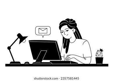 Young female employee corresponds by email while sitting at a computer at her workplace