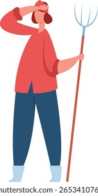 Young female farmer holding a pitchfork and shielding her eyes from the sun with her hand in a rural setting, symbolizing hard work and dedication in agriculture