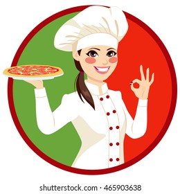 Young female Italian chef holding pizza and making ok sign with Italy flag on background