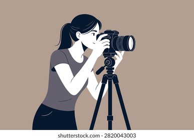 Young female photographer using a professional camera on a tripod to capture a high-quality image in a monochrome studio setting.