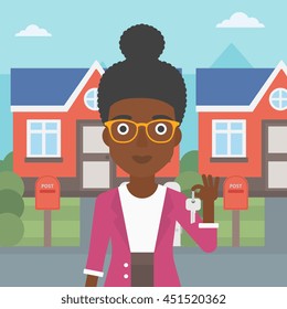 Young female real estate agent holding key. An african-american woman with keys standing in front of the house. Happy new owner of a house. Vector flat design illustration. Square layout.