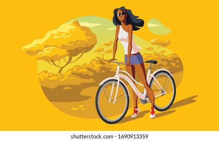 Young female standing with bicycle at the park
