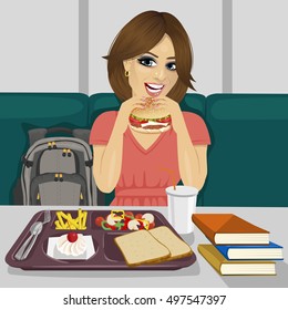 young female student having lunch in fast food restaurant