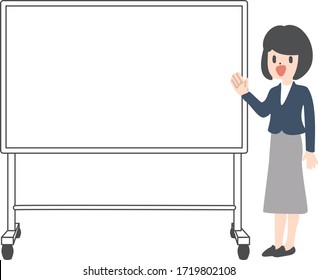 Young female teacher on lesson at blackboard in classroom.
