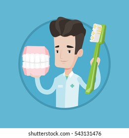 Young friendly dentist holding dental jaw model and a toothbrush in hands. Male dentist showing dental jaw model and toothbrush. Vector flat design illustration in the circle isolated on background.