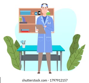 Young friendly doctor with otolaryngological forehead mirroror standing and holding clipboard. Man in blue medical gown in doctor’s office near the examination table. Shelves with professional items