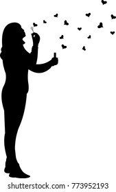 Young girl blowing soap bubbles in heart shaped for Valentine s Day silhouette