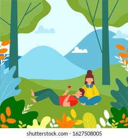 Muchacha y niño que yacen bajo el corazón mostrando desde la mano un hermoso paisaje natural de fondo.