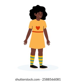 Young girl with curly hair in yellow dress and colorful socks standing happily