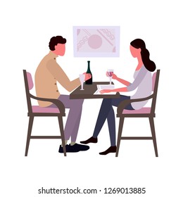 A young girl and a guy sit at the table and drink wine. Acquaintance or rest in a restaurant
