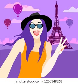 
young girl in a hat and glasses travels to paris. makes selfie on the background of the Eiffel Tower
