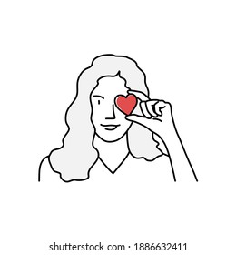 Young girl with a heart near her eye. Hand drawn vector illustration. 