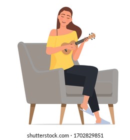 Una chica joven está jugando ukulele.