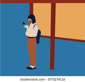 Young girl with protective mask using smartphone at bus stop during covid-19. Coronavirus outbreak new normal lifestyle.