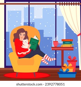 Young girl reading book and resting with  cat on comfortable yellow armchair. Cute woman read book at home. Nice leisure on christmas holidays with interesting book 
