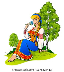 Young girl in Russian national costume on a background of nature.