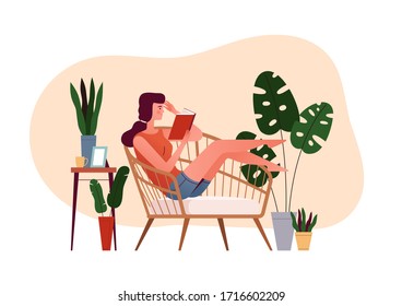 Young girl sits in an armchair and reads a book. The concept of a cozy reading at home. Home daily activities