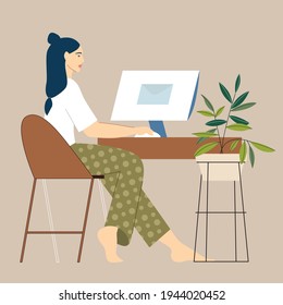 Una niña sentada en una computadora. trabajar a distancia.