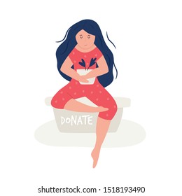 Young girl sitting on a container for donations. Charity concept with cute activist