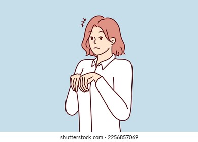 Young girl stands like puppy or bunny, bending palms near chest in pose symbolizing obedience and humility. Attractive woman in white shirt looks at screen in embarrassment