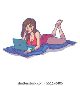 Young girl using laptop while lying on the floor