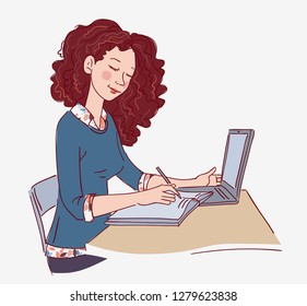 Young girl using laptop and writing in notebook