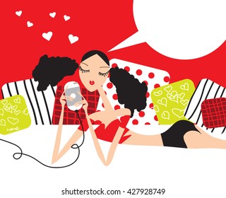 Young girl using a mobile phone lying on the bed at home