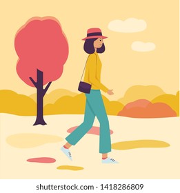 Young girl walking in orange and yellow autumn background, cartoon woman in stylish outfit going through a park in fall season enjoying nature, flat hand drawn vector illustration