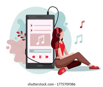 Young girl wearing headphones. Girl listening to music with mp3 player and smartphone.
