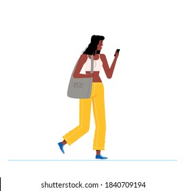 Young girl in a white T-shirt and yellow tights walks down the street. Woman with gray bag looking at the phone