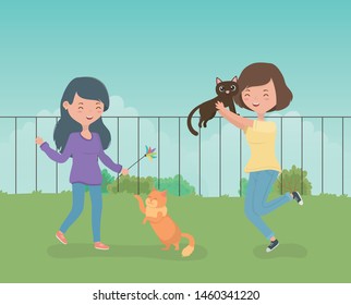 young girls with cute little cats mascots in the field