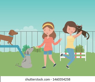 young girls with cute little dogs mascots in the field