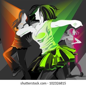 Young girls dancing at the club under the spotlight