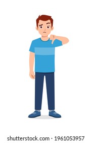 young good looking man doing thumb down pose