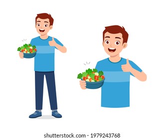 young good looking man eat fruit and vegetable