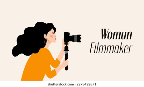 Young Gorgeous Woman Holding Camera Filming and Photography. Independent working women. Successful Brunette Photographer taking photos. Photoshoot.