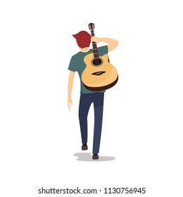 Young guitarist walking